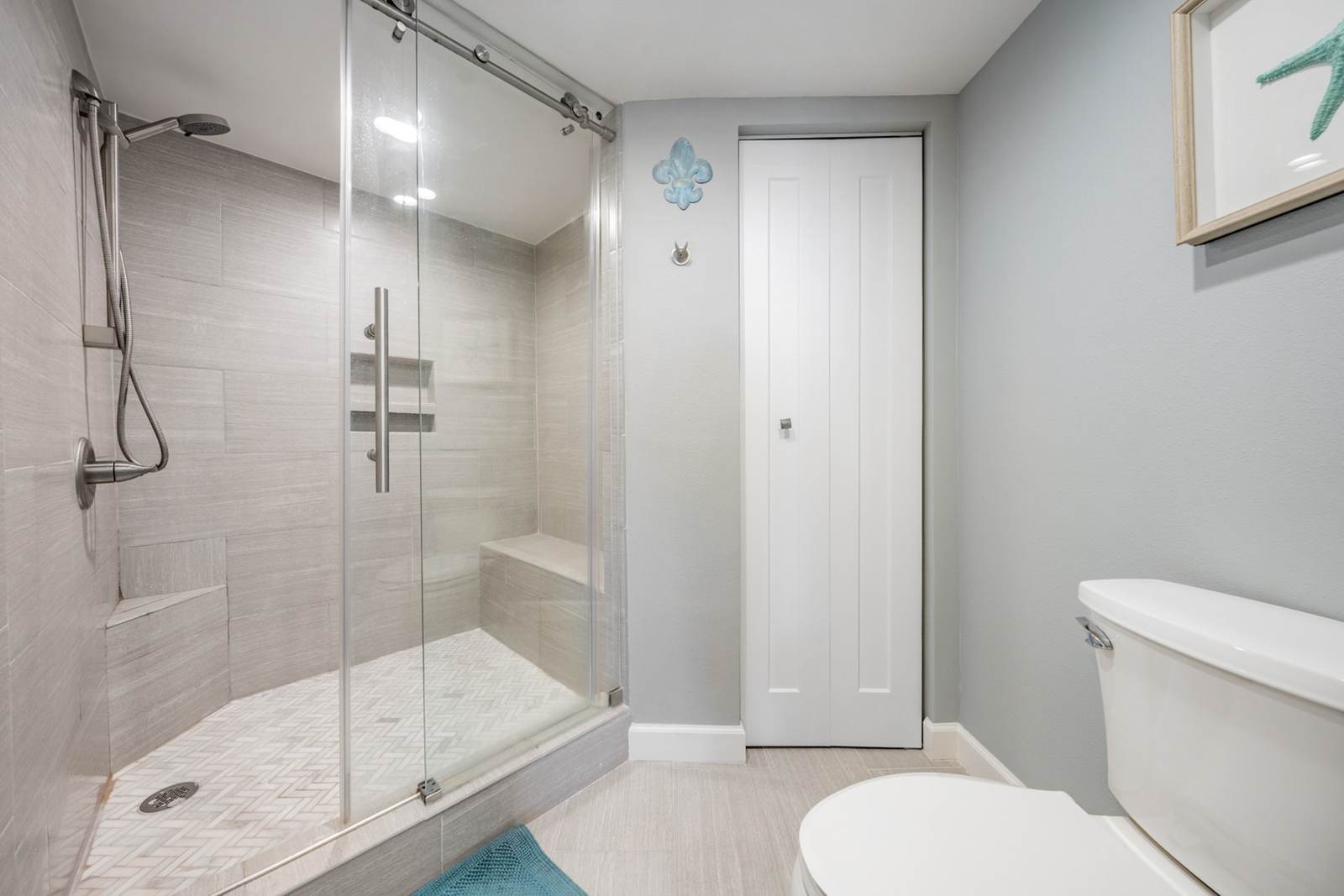 Walk-in tiled shower with glass door